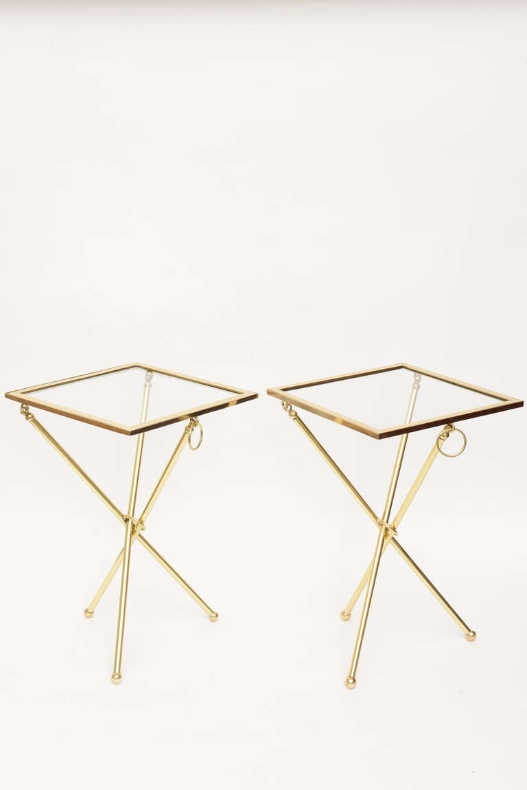These very clever and never used Chapman folding tripod polished brass and glass are very chic!
They have the 3 tripod legs with ball feet and rings at each side.
They are signed.
They can fold flat for storage or hang on a wall.

PLEASE