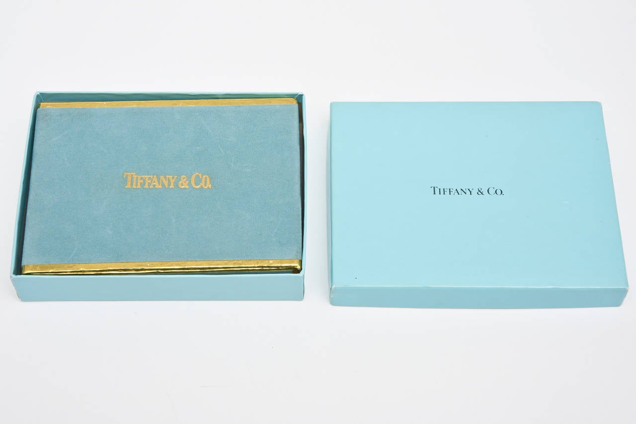 These never opened or used Tiffany playing cards are vintage.
It is a lovely Tiffany box within the original card playing box.
The cardholder box is a tiffany blue velvet with gold trim. It slides out with a tab to the playing cards that are still