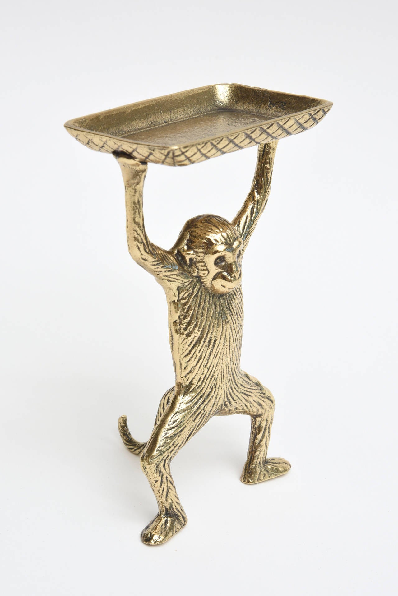 The delightful and strong monkey looks like he is holding up an entire brick.
It is solid brass with incised blackened lines and is vintage.
Great use for a card holder, paper clips, or soap for a bathroom.
