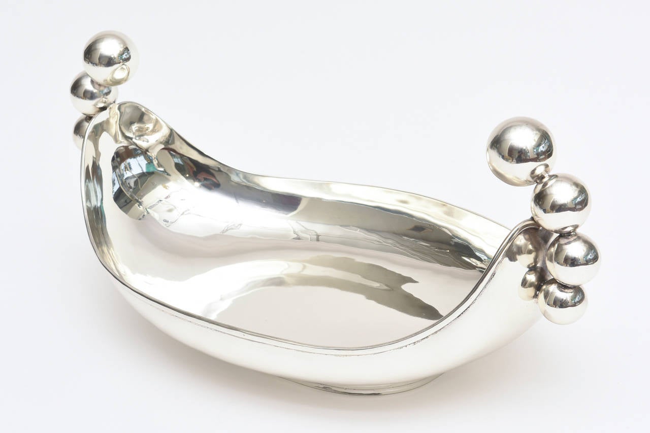This beautiful signed and hallmarked sterling silver bowl by C. Zurita is a piece of sculpture. The purposes are multiple as a centerpiece bowl or as a serving bowl or as a sterling silver object with sculptural form.
It has been professionally