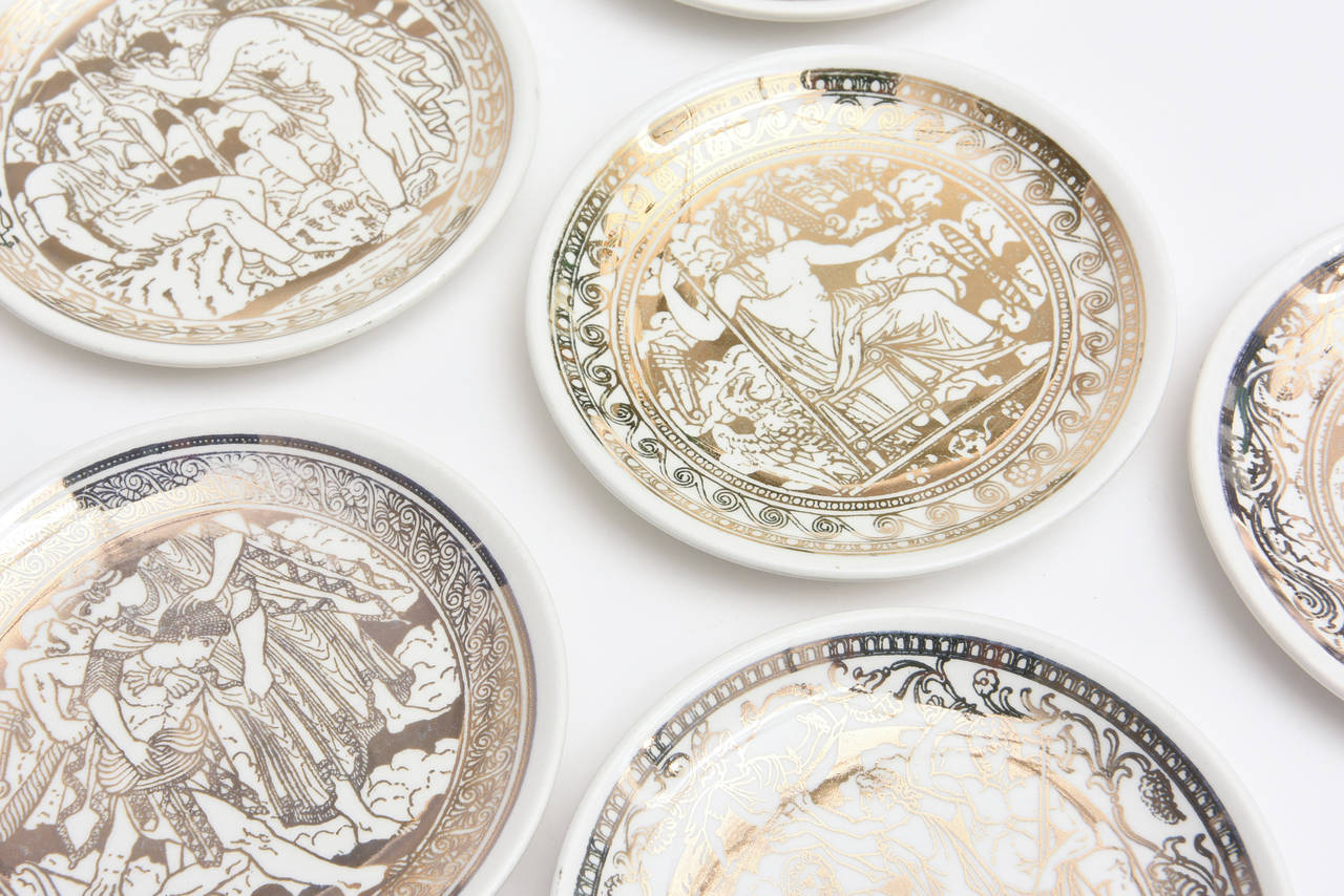 These classic Greek mythological scenes of Fornasetti's vintage gilded porcelain coasters/small plates are classical Italian. They are all hallmarked on the back of the coaster/plate and are entitled "Mitoligia." They have Greek warriors,