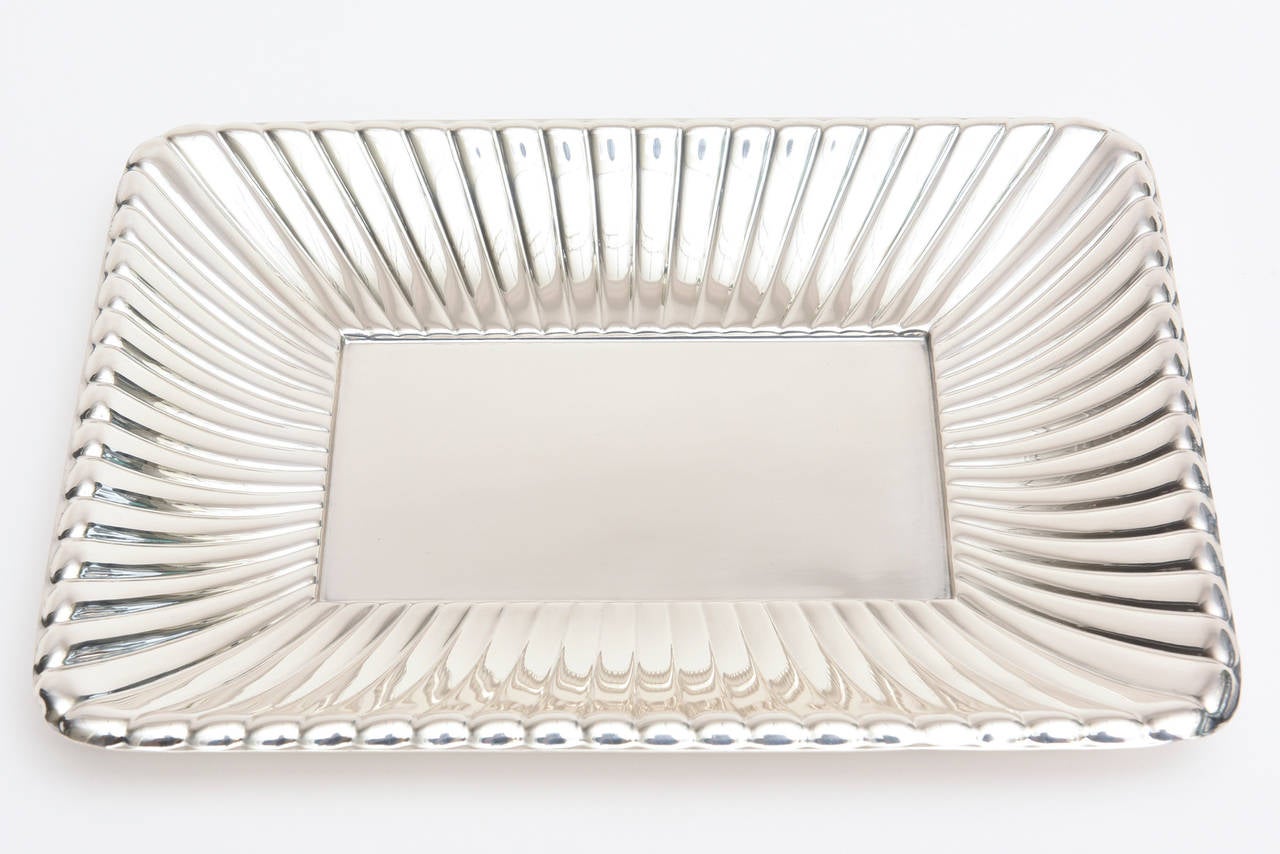 This wonderful hallmarked sterling silver serving/fruit tray/ bowl by Reed and Barton has all kinds of cartouche hallmarks on it along with number on the back.
The radiating ribbed edges that surround the lovely tray add beautiful dimension and a