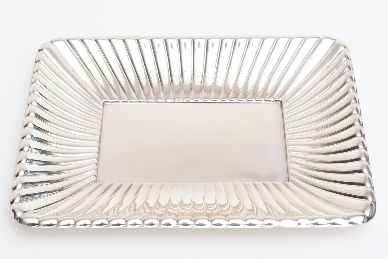 This wonderful hallmarked sterling silver serving/fruit tray/ bowl by Reed and Barton has all kinds of cartouche hallmarks on it along with number on the back.
The radiating ribbed edges that surround the lovely tray add beautiful dimension and a