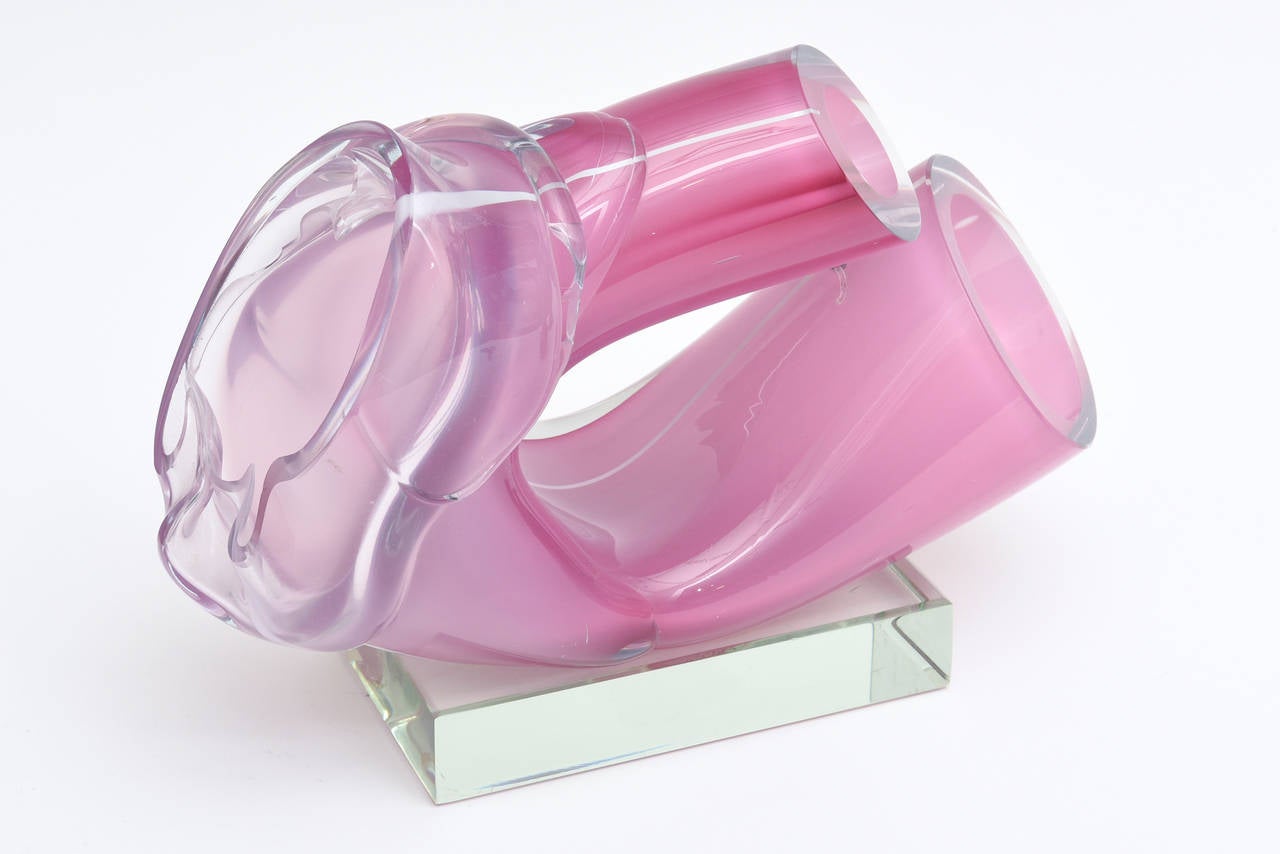 This sensual, abstract and bright hued one of a kind piece of sculptural handblown glass by renowned American glass artist: Harvey Littleton is fantastic and abstract.
It is a cut folded form which he is famous for. This particular work is not