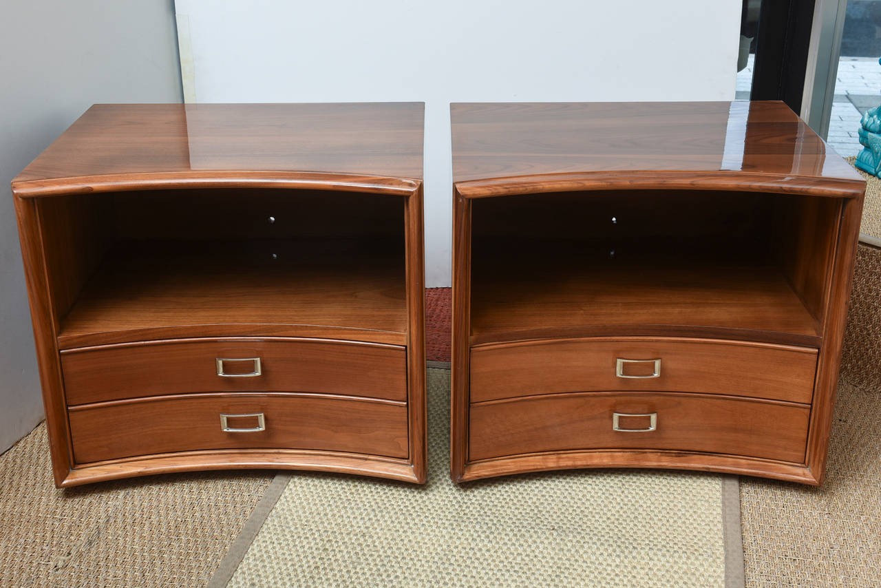 These midcentury restored pair of Paul Frankl for Widdicomb nightstands have both the 2 bottom drawers and a center open area like a shelf for books and magazines. They have a semi curve to the front.
The beautiful grains of the walnut wood are so