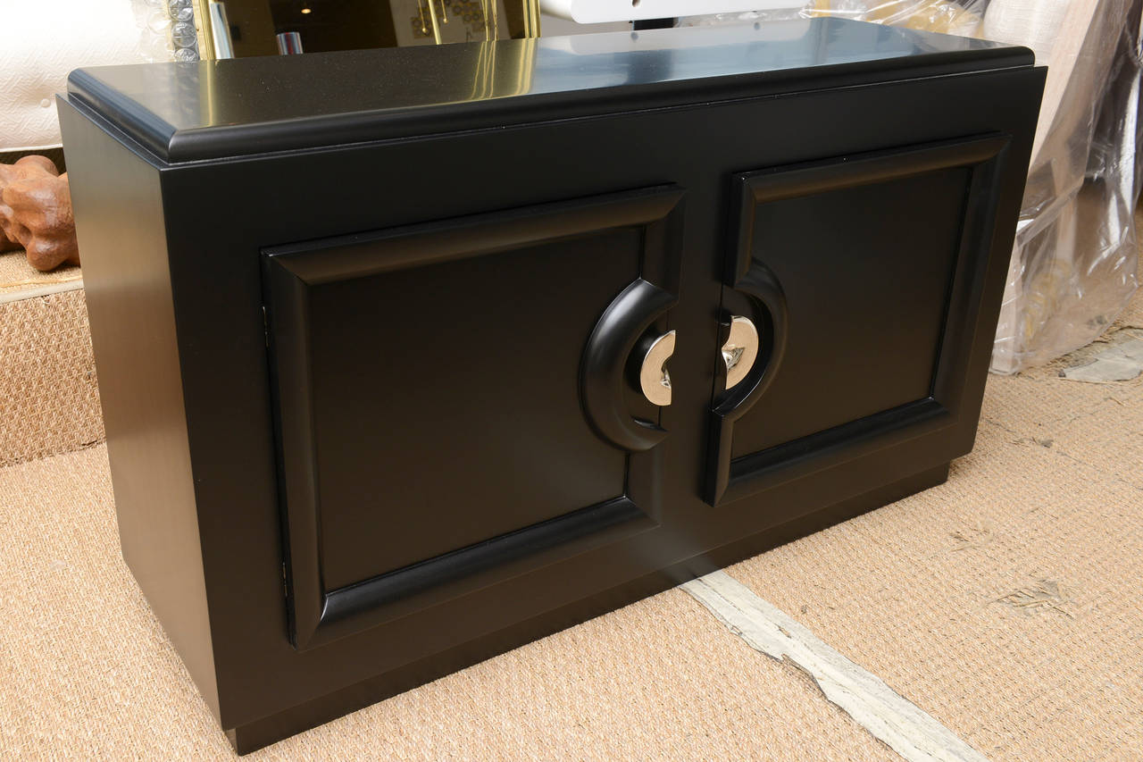 This lovely cabinet, in the style of Paul Laszlo has original nickel silver hardware.
It has been ebonized.