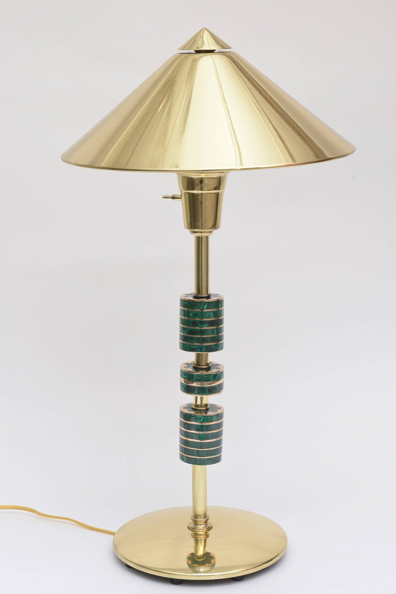 This amazing Mid-Century Modern lamp is in the style and attribution of the Mexican artist, Pepe Mendoza. It is lovely with its original brass shade with a white enameled metal coating underneath. The pagoda style brass shade is all original. It has