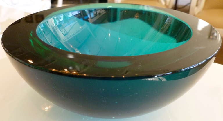 The colors of the sea; deep rich turquoise to sapphire blue to Caribbean green rim are the colors of this Italian Murano bowl. This heavy large flat cut geode bowl is stunning!
Attributed to Seguso.