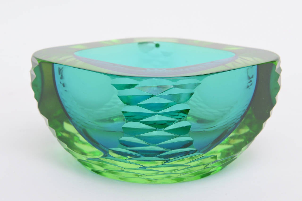 This piece de resistance rare and magnificent Murano heavy glass geode flat cut polished bowl is attributed to Antonio da Ros for Cenedese. Not only are the colors the most luscious in sea greens to emerald to turquoise but they graduate from top to