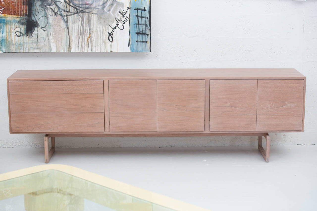 Scandinavian buffet in bleached teak
with three drawers and two pairs of doors with the shelves behind. Measures: 8 ft long.

 