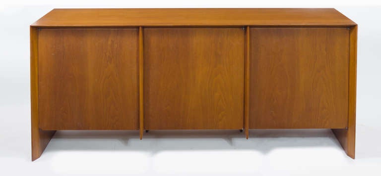 Walnut Buffet-Credenza by T.H.Robsjohn-Gibbings for Widdicomb with three recessed doors, six drawers and two shelves, middle top drawer
fitted with feltlined trays or silverware.
Widdicomb silk label inside top drawer.
On display @ ENTREPOT 
296