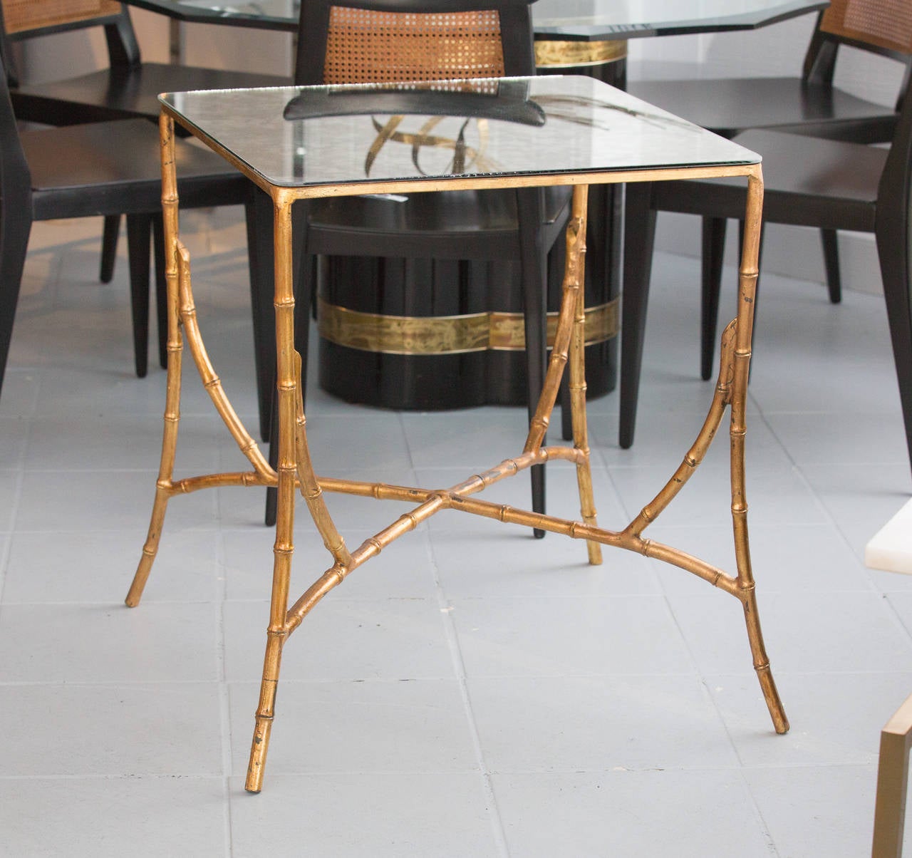 Two Side Tables in a Maison Jansen Style with faux bamboo bases
and antiqued bronze mirror tops.
The tables are not a pair, each different size.