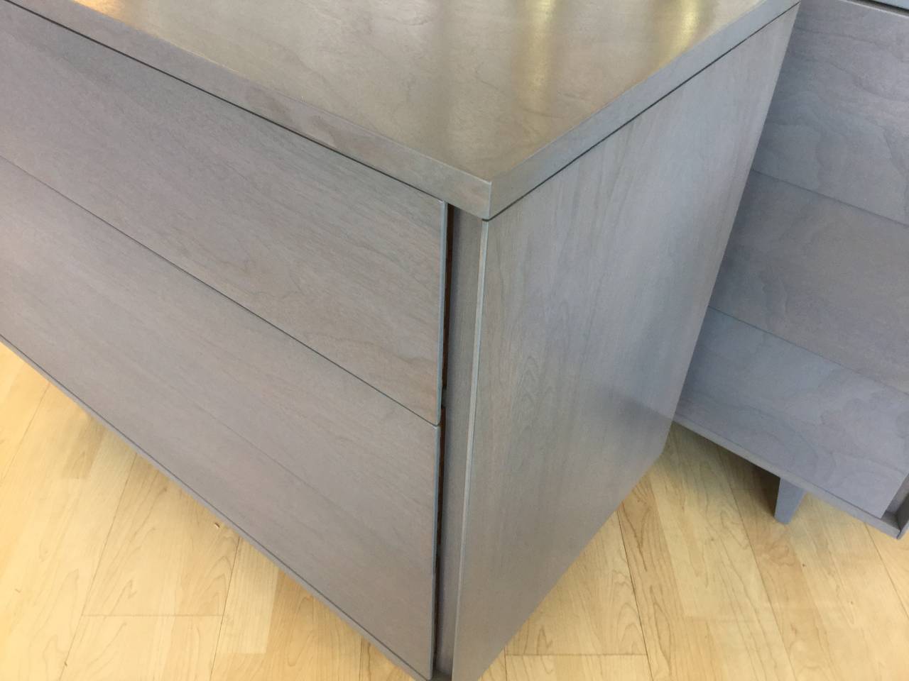 Pair of three drawer Dressers by John Stuart Inc. 
with integrated side pulls,
Gray cerused finish on walnut.
John Stuart Inc Metal tag in top drawers.