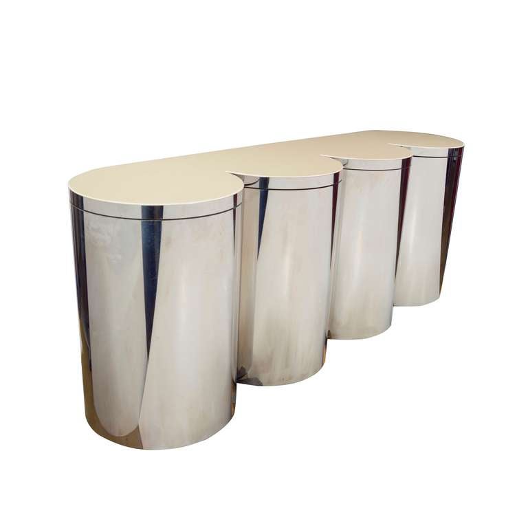 Four steel drums with revolving doors with shelves behind.
Composite glass and Acrylic top with a knife edge detail.
Two drums lined with the Ultrasuede .
Designed by Paul Evans c 1981,
Created by Paul Evans Studio.
Recently published at the