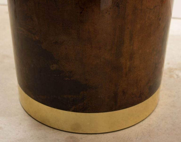 Round pedestal table by Aldo Tura in lacquered goat skin 
incorporating a recessed ice bucket / planter 
made of polychromed aluminum with the matching goat skin cover.
On display at 
849 NE 125th St, North Miami location.