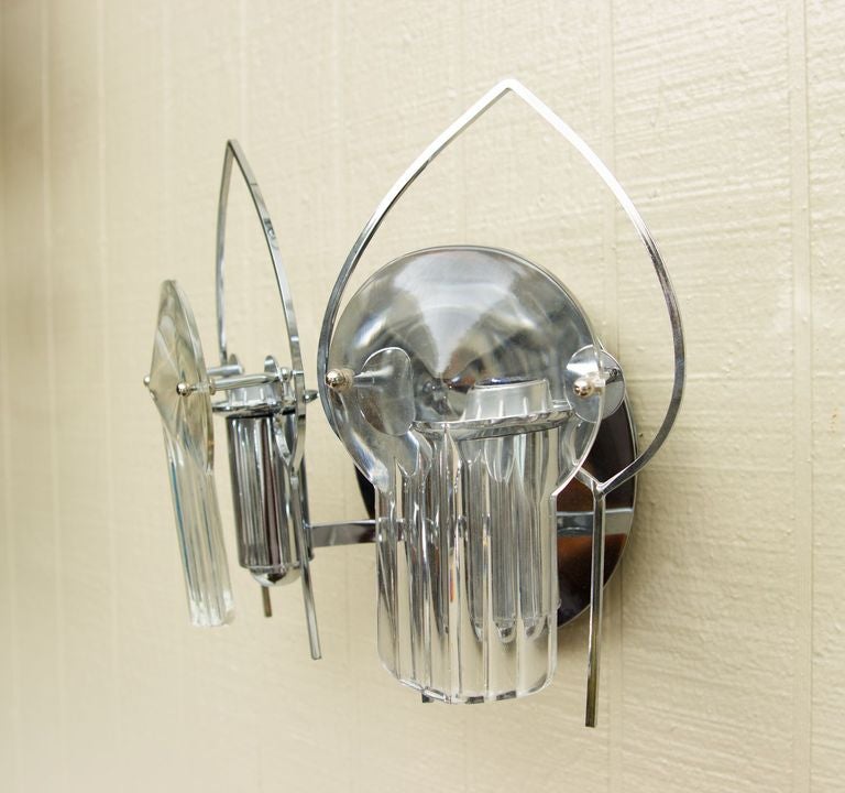 Pair of Sconces featuring two lights each with 
a swivel frames attached to a round mounting plate in chrome finish.
Optical glass diffuser in front of each socket.
Label attached.