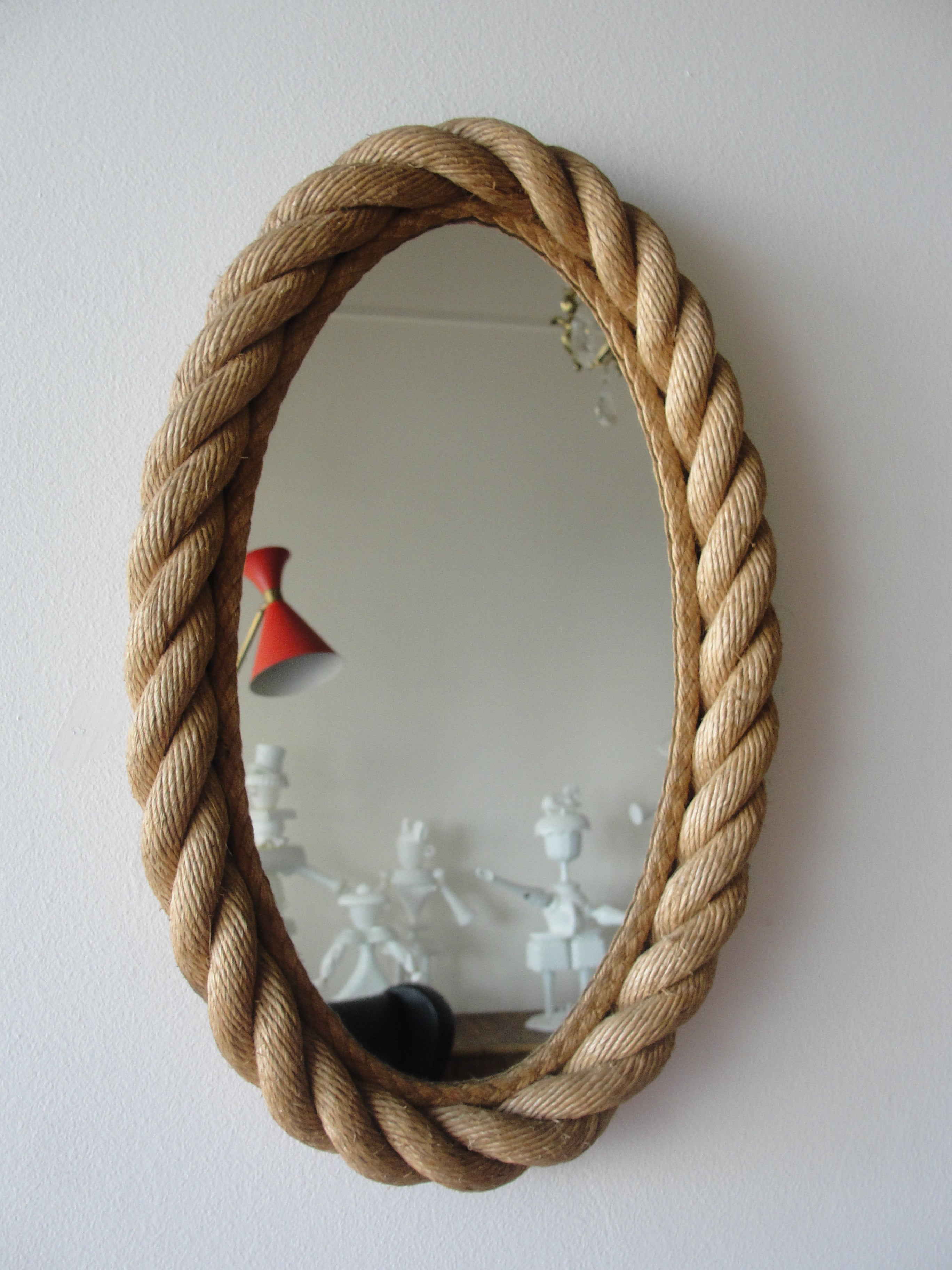 Braided rope frame oval mirror, with rope edge between glass and braided rope border by Audoux et Minet, French, 1950s.

This item is currently in our MIAMI facility.