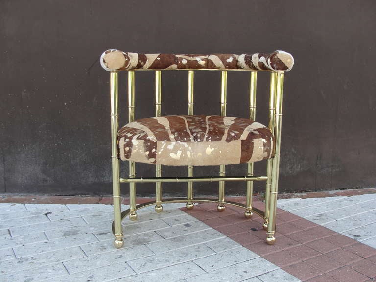 Beautiful and heavy, finished with a zebra print cowhide leather with gold metallic spots. This is a perfect single accent chair. Heavy and sturdy.