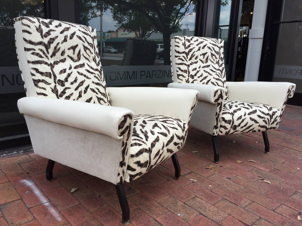 1950s Italian chairs newly restored black metal geometrical legs with brass gliders (original).

Upholstered in three different materials (Animal print cotton, ivory leatherette on the armrests, and complimentary ivory velvet side panels). Note: