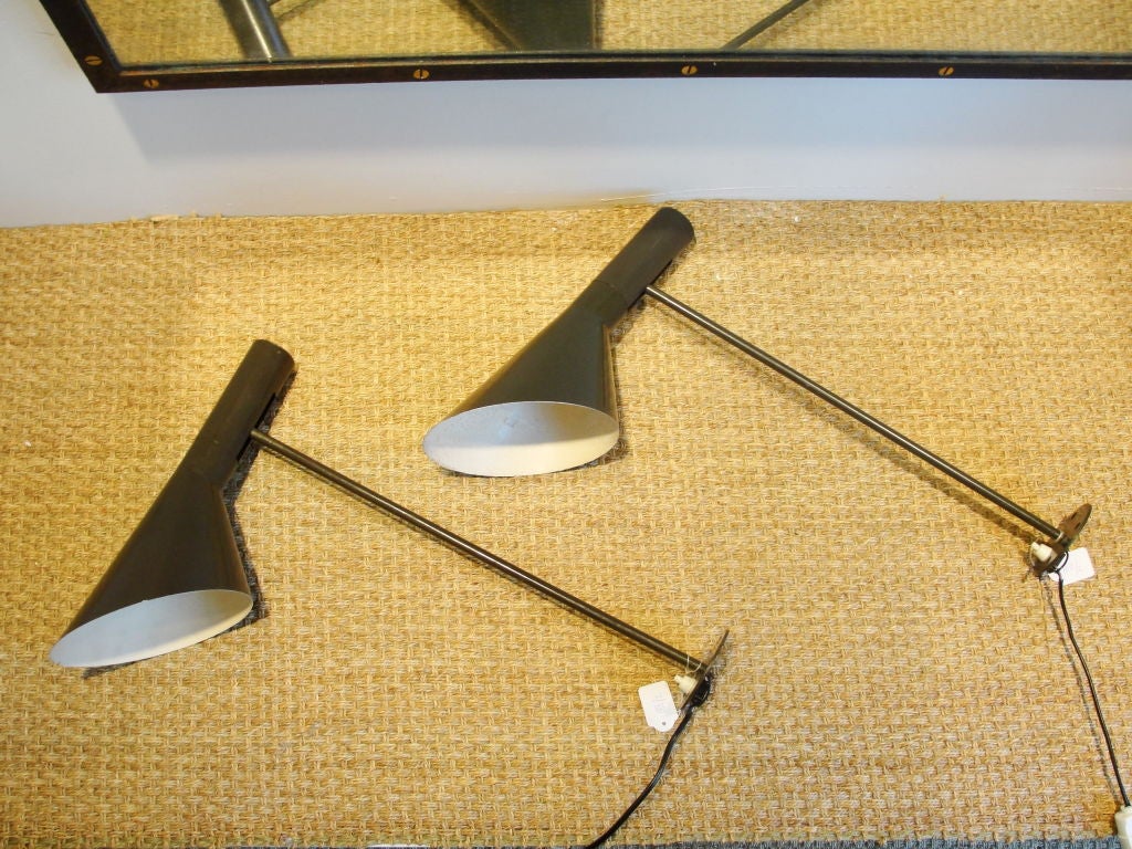 Iconic Arne Jacobsen design.  These long armed wall lights are extremely hard to find.  Original vintage working condition. Original on/off switch on base and original Grey Color. These lamps were purchased at Sotheby's.