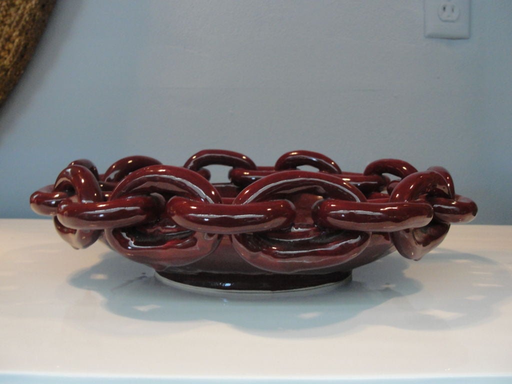 Finish in a high-glaze burgundy color, this chain ink trimmed bowl/platter is simply stunning.

This item is currently in our MIAMI facility. Please call or email us directly for details.