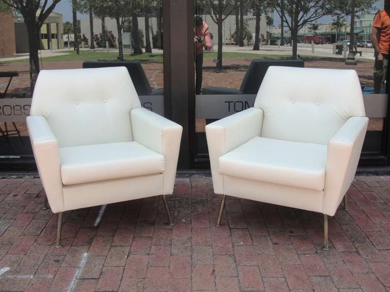 Two 1950s Italian Armchairs Reupholstered in Soft beige Faux Leather Fabric, with brass legs.