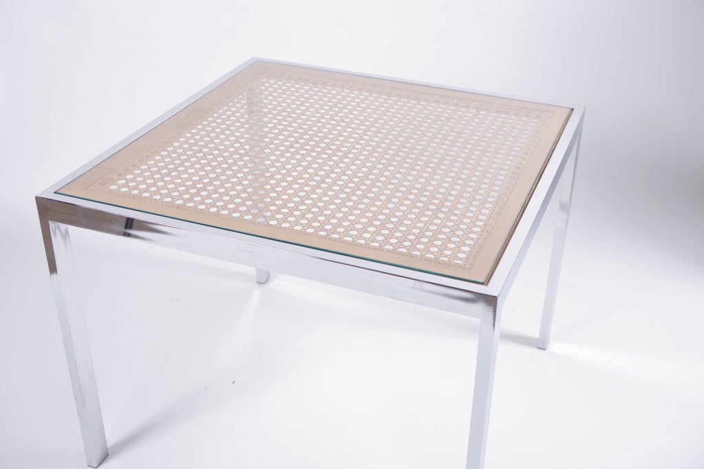 Glass top covers and intricate wicker weave and framed in chrome. 
Note dimensions are: 28 inches H x 36 in D x 36 wide