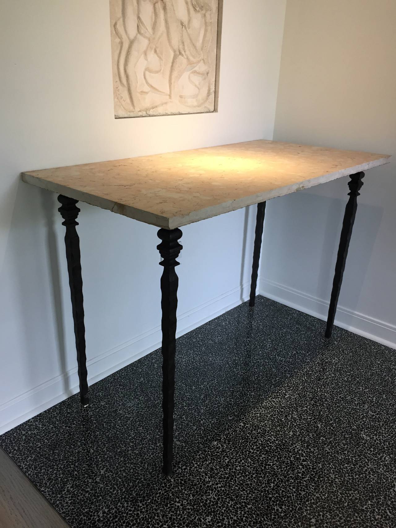 Iron and marble-top console serving table with blackened iron base and brass sabots in the Giacometti style; The marble top is Pink Lez Breccia marble opaque dusty salmon pink with open veined, Marble top is from the Haute-Garonne region of southern