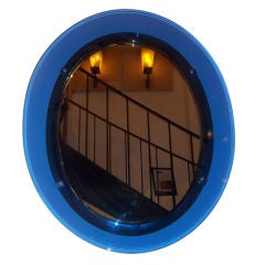 A Blue Glass Framed Oval Wall Mirror by Fontana Arte