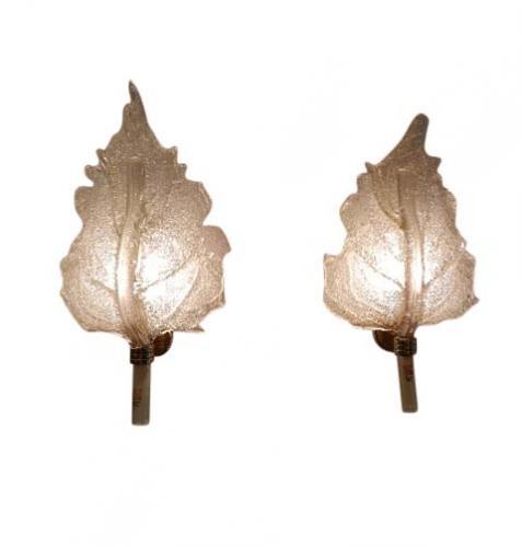A pair of wall sconces each featuring a brass wall mount which holds a leaf shaped light diffusing shade in handblown molded opaque glass with gold inclusions. The sconces have their original Barovier e Toso label and are signed on the brass wall