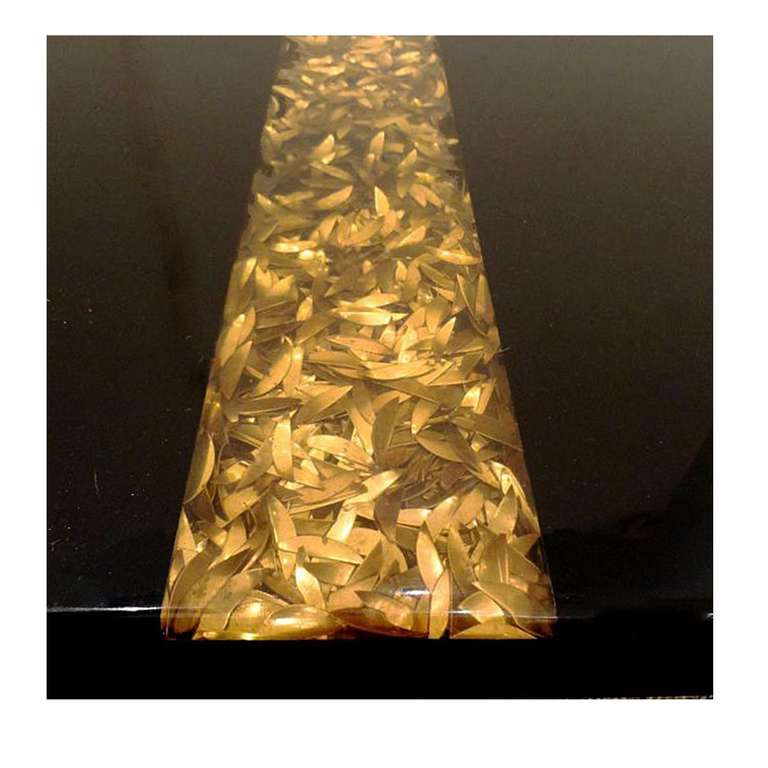A large cocktail table in resin with an inset panel of shards of brass encased in golden resin. Christian Krekels, Belgium circa 1970.