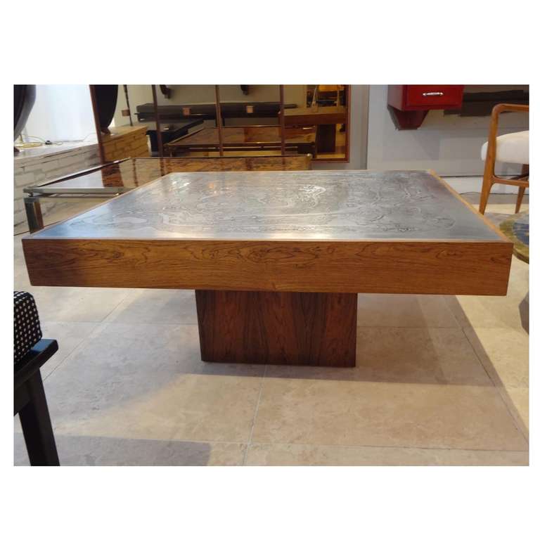 A large square cocktail table featuring a square platform base and deep skirt in Rosewood with a top in acid etched steel. In the style of Christian Krekels, Belgium circa 1970.