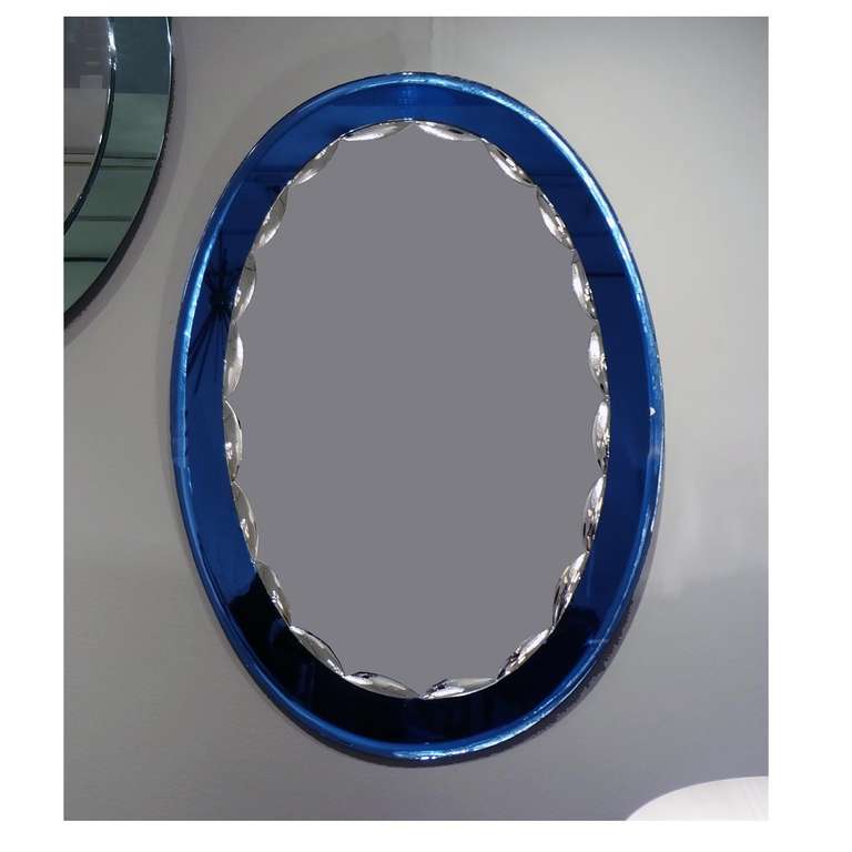 A Mid-Century oval mirror featuring a blue beveled mirror frame with a centurial clear mirror with a scalloped beveled edge. In the style of Fontana Arte, Italy, circa 1960.