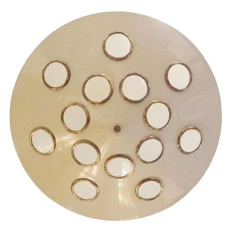 A grand scaled mid century chandelier featuring a bowl shaped shade in off white lacquered metal with round cut outs, each with an opaque light diffusing lens ringed in brass. The chandelier also features a off white lacquered hanging cylinder and