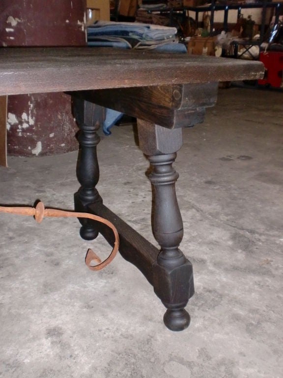 Spanish library table or desk. Metal stretcher with side splayed legs. Top has old indents as shown on photo
