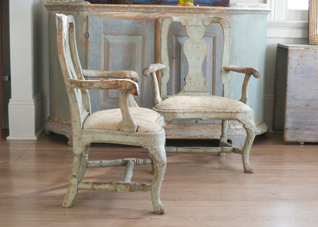 Pair of rococo armchairs of bold design; original paint in grey-green.