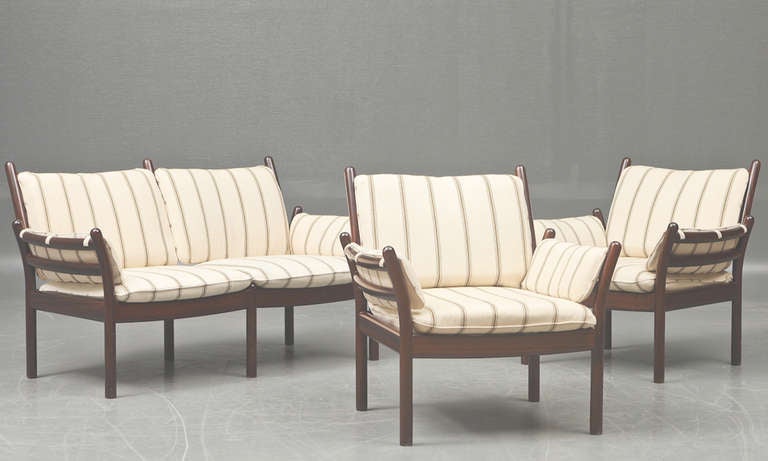 Danish modern loveseat and armchairs by Danish designer Illum Wikkelso. The set with mahogany frames and upholstered in striped wool fabric. Note. Armchair dimensions are 30
