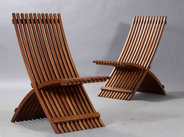 A pair of large Danish mahogany folding garden chairs of slatted form, marked Solaris. Note:  Another pair is available plus a matching table. Note: Depth is maximum.