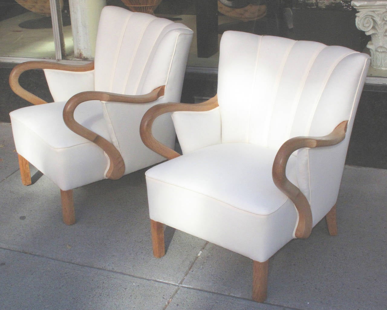 Pair of large Danish 1940s oak frame armchairs with channeled backs and exaggerated curved open arms.