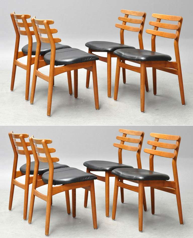 Set of eight ladder-back oak dining chairs by Poul Volther. Note that four chairs are upholstered in black-leather and the other four are in striped wool so they would have to be reupholstered to make a matched set, see detail photos.