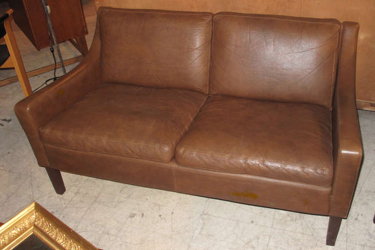 Danish Modern Small Two-Seater Leather Upholstered Loveseat with Mahogany Legs; Circa 1960s.
