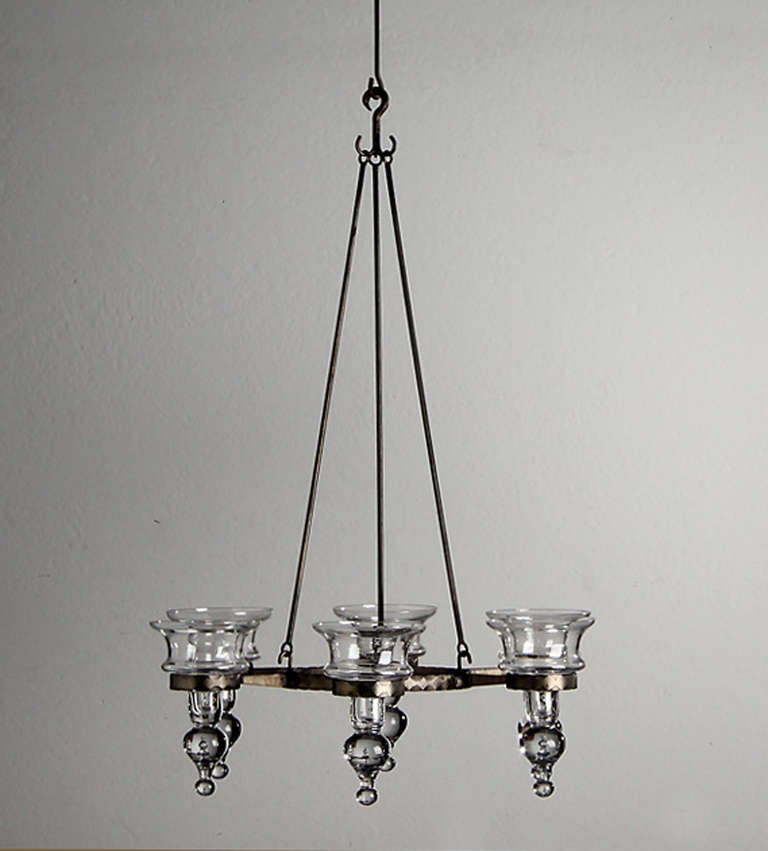 Wrought iron chandelier, 1940s with inset glass bobeches as tea lights. Bobeches easily come out for cleaning.