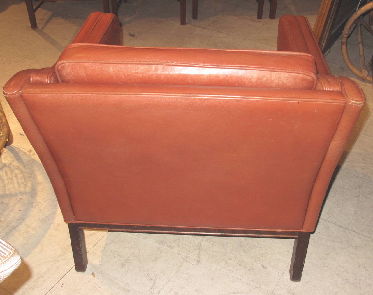 Danish large-scale club chair upholstered in brown leather, the frame of stained beech, circa 1960s.