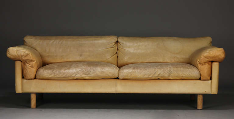The sofa upholstered in light good quality leather and on beech legs. Circa 1970s.