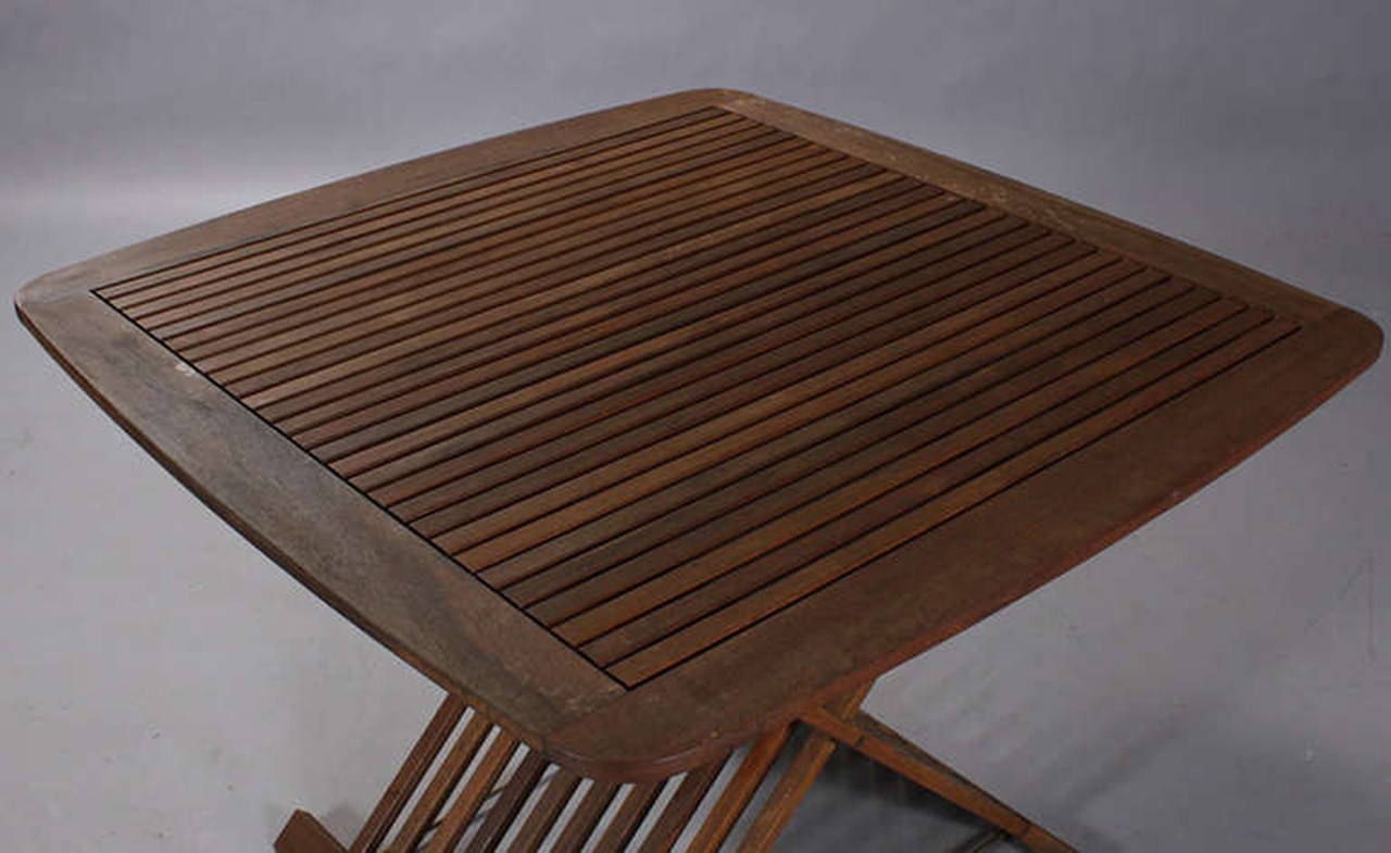 Set of Danish early 1960s mahogany folding garden furniture of slatted form. The set comprised of four chairs and a matching table. Chairs measure 36