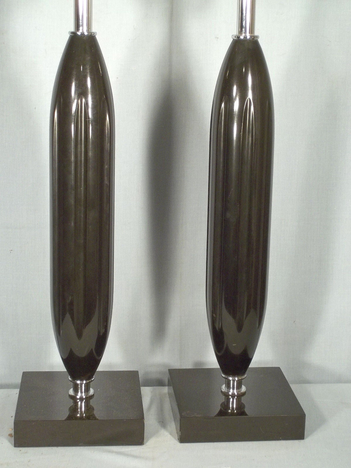 Pair of large-scale sculptural black marble and chrome table lamps. The lamps consisting of elongated bullet form black marble center pieces with repeating indented design mounted with chrome fittings. The lamps on black marble bases, circa 1970s,