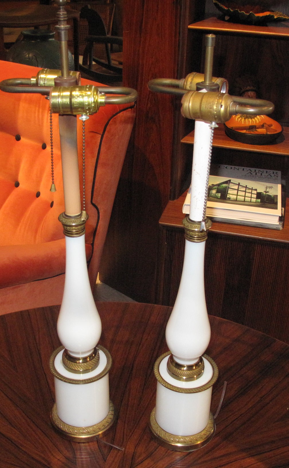Pair of French 1820s gilt-metal and balustrade form opaline glass candlesticks adapted into lamps. Note: Measurement given is to top of finial, glass and gilt-metal part measures 16
