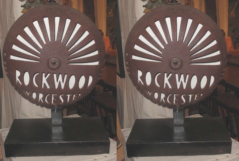 Pair of mid-20th century pierced wrought iron alarm covers mounted as sculpture. The covers with company name Rockwood Worchester. Would be great wired as table lamps. Note: Can work as pair, one looks lighter in photo but that is only because of
