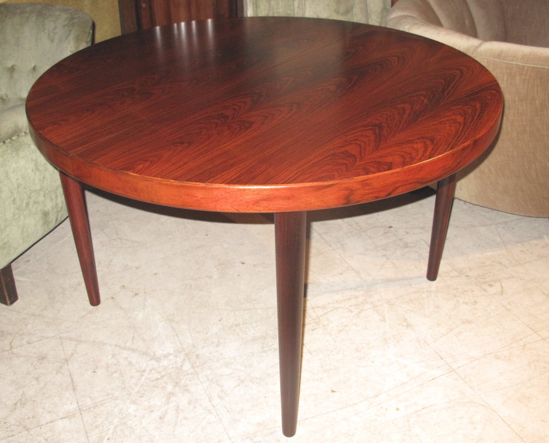 Danish Early 1960s Extending Dining Table of Beautifully Figured Rosewood with One Leaf.  Extends from a circular table 45