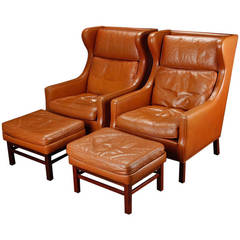 Pair of Large-Scale Danish Modern Leather Wing Chairs and Ottomans